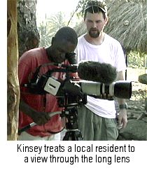 Jim Kinsey looks on as a local teen peeks through the XL1 viewfinder.