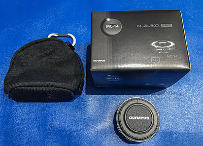 Four Olympus Micro 4/3 lens and flash-olympus-converter.jpg